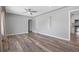 Open-concept living room leading to the kitchen with wood flooring, neutral walls, and recessed lighting at 2582 S Uno Way, Denver, CO 80219