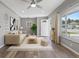 Bright living room features a ceiling fan, large window, and neutral decor and accents at 2582 S Uno Way, Denver, CO 80219
