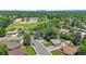 Scenic aerial shot of the neighborhood showcasing mature trees, a school, and a glimpse of the city skyline at 2582 S Uno Way, Denver, CO 80219