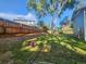 Spacious backyard featuring a retaining wall, tall tree, and a wooden fence adding privacy at 6207 W 92Nd Pl, Westminster, CO 80031