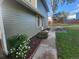 Side yard featuring walkway, flower beds, picnic table and lush green lawn at 6207 W 92Nd Pl, Westminster, CO 80031