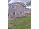 Back exterior of house with green siding and view of large backyard at 6207 W 92Nd Pl, Westminster, CO 80031