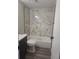 Modern bathroom with elegant marble tiling, sleek black hardware, and a luxurious bathtub at 6207 W 92Nd Pl, Westminster, CO 80031