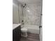 Modern bathroom with elegant marble tiling, sleek black hardware, and a luxurious bathtub at 6207 W 92Nd Pl, Westminster, CO 80031