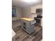 Modern kitchen with island featuring stainless appliances and butcher block countertop at 6207 W 92Nd Pl, Westminster, CO 80031