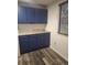 Cozy laundry room offering ample storage with blue cabinets and light countertops at 6207 W 92Nd Pl, Westminster, CO 80031