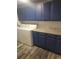 Functional laundry room features blue cabinets, granite countertops, and modern washer/dryer at 6207 W 92Nd Pl, Westminster, CO 80031