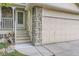 Close-up view of the entrance, showcasing stone accents and a well-maintained front door at 12021 Dahlia Dr, Thornton, CO 80241