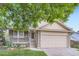 Inviting home with a covered porch and stone accents, offering a blend of comfort and style at 12021 Dahlia Dr, Thornton, CO 80241