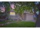 Charming home featuring a stone facade, a welcoming front porch and beautifully landscaped front yard with rock accents at 12021 Dahlia Dr, Thornton, CO 80241