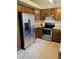 Updated kitchen featuring stainless steel appliances and classic wood cabinetry at 12021 Dahlia Dr, Thornton, CO 80241