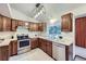 Functional kitchen with ample counter space, stainless steel appliances, and wood cabinetry at 12021 Dahlia Dr, Thornton, CO 80241
