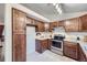 Well-equipped kitchen with wood cabinets, stainless steel appliances, and efficient layout at 12021 Dahlia Dr, Thornton, CO 80241
