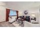 Inviting living room featuring large windows, plush seating, and elegant accents at 12021 Dahlia Dr, Thornton, CO 80241