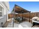 Outdoor back patio with a gas grill and a dining area with tasteful decor for the perfect gathering at 1535 Spruce St, Denver, CO 80220