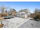 Backyard view features a two-story home, a storage trailer, and a patio area surrounded by grass at 1535 Spruce St, Denver, CO 80220