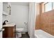 Cozy bathroom featuring a shower with tile surround, wood cabinet, and modern fixtures at 1535 Spruce St, Denver, CO 80220