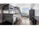 Charming bedroom with bunk beds, hardwood floors, and abundant natural light from double windows at 1535 Spruce St, Denver, CO 80220