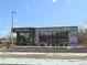 Street view of Pablo's Coffee shop with purple and black exterior and unique mural details at 1535 Spruce St, Denver, CO 80220