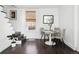 Dining area with modern table, chairs, and hardwood floors with natural light from large window at 1535 Spruce St, Denver, CO 80220