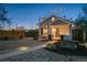 Exterior view of the home at dusk features manicured yard and gravel landscaping at 1535 Spruce St, Denver, CO 80220