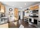 Spacious kitchen with stainless steel appliances and wood cabinets, providing ample storage and modern amenities at 1535 Spruce St, Denver, CO 80220