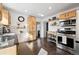 Open kitchen with stainless steel appliances, granite countertops, and wood cabinets at 1535 Spruce St, Denver, CO 80220