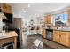 Well-lit kitchen featuring a breakfast bar, stainless steel appliances, and natural light at 1535 Spruce St, Denver, CO 80220