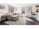 Bright living room with hardwood floors, large windows, and comfortable seating arrangement at 1535 Spruce St, Denver, CO 80220