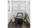 Sitting area with a gray chair, side table, hardwood floors, and a plant at 1535 Spruce St, Denver, CO 80220