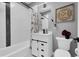 Cozy bathroom featuring a shower-tub combination, a modern vanity, and stylish decor at 8885 W 64Th Pl, Arvada, CO 80004