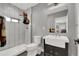 Modern bathroom featuring a walk-in shower with white tile and a stylish vanity at 8885 W 64Th Pl, Arvada, CO 80004