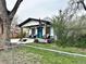 Charming home featuring a stylish front porch and a vibrant blue door under a cloudy sky at 8885 W 64Th Pl, Arvada, CO 80004