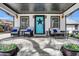 Inviting front porch with comfortable seating and vibrant blue front door with a decorative star at 8885 W 64Th Pl, Arvada, CO 80004