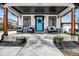 Inviting front porch with comfortable seating, potted plants, and a distinctive blue front door with star decor at 8885 W 64Th Pl, Arvada, CO 80004