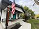 Charming home featuring a cozy front porch with a sitting area and stylish decor and flag accents at 8885 W 64Th Pl, Arvada, CO 80004