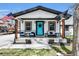 Charming home with a quaint front porch, complete with seating and patriotic flags at 8885 W 64Th Pl, Arvada, CO 80004