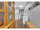 Well-lit hallway featuring hardwood floors, a freezer, and seamless access to multiple rooms at 8885 W 64Th Pl, Arvada, CO 80004
