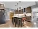 Stylish kitchen featuring a center island with seating and modern lighting at 8885 W 64Th Pl, Arvada, CO 80004