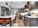 Modern kitchen with dark cabinetry, white countertops, and stainless steel appliances at 8885 W 64Th Pl, Arvada, CO 80004