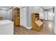 Versatile room featuring hardwood floors, ample storage cabinets, and flexible space for various needs at 8885 W 64Th Pl, Arvada, CO 80004