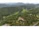 Aerial view of large home surrounded by trees and greenery at 2929 Highlands View Rd, Evergreen, CO 80439