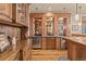 Close up of the bar area with wooden cabinets, mini refrigerator and sink at 2929 Highlands View Rd, Evergreen, CO 80439
