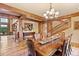 Inviting dining area showcasing hardwood floors, wooden beams, and stylish decor at 2929 Highlands View Rd, Evergreen, CO 80439