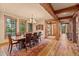 Elegant dining room featuring hardwood floors, wooden beams, a chandelier, and large windows at 2929 Highlands View Rd, Evergreen, CO 80439
