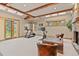 Bright exercise room featuring high ceilings, skylights, treadmill, and stationary bike at 2929 Highlands View Rd, Evergreen, CO 80439