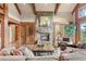 Inviting living room with stone fireplace, wood accents, and cozy seating at 2929 Highlands View Rd, Evergreen, CO 80439