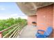 Spacious balcony area with brick siding, trees, and city views at 5955 E 10Th Ave # 507, Denver, CO 80220