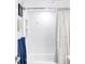 Clean and bright bathroom showcasing a tiled shower and decorative curtain at 5955 E 10Th Ave # 507, Denver, CO 80220