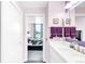 Bathroom with white countertops and lilac walls viewed from the doorway with a bedroom in the background at 5955 E 10Th Ave # 507, Denver, CO 80220